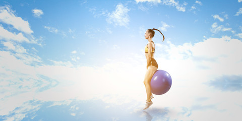 Sporty woman on fitness ball. Mixed media