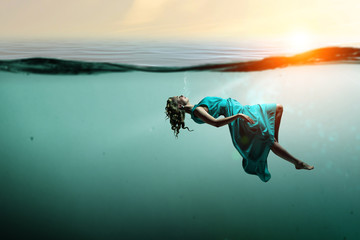 Fototapeta na wymiar Woman dancer in clear blue water