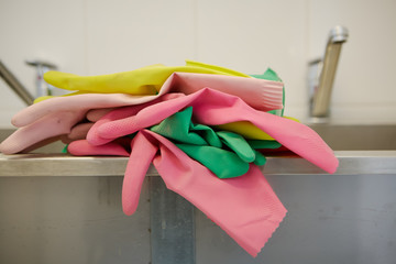 Multi-colored rubber gloves for cleaning are in the kitchen
