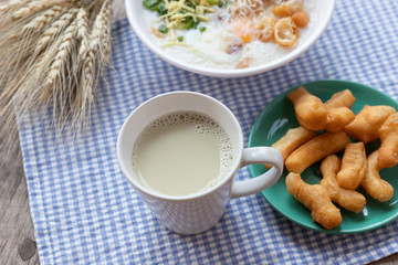 Breakfase meal. Congee or Rice porridge minced pork, boiled egg with soy milk and Chinese deep fried double dough stick