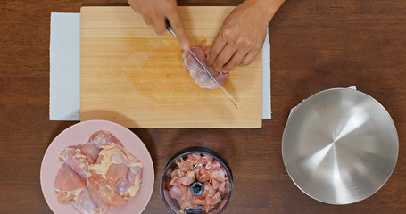 Top view of chopping chicken fillet