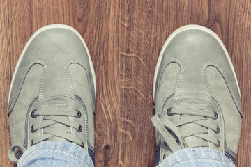 Comfortable gray leather shoes on rustic board, male footwear