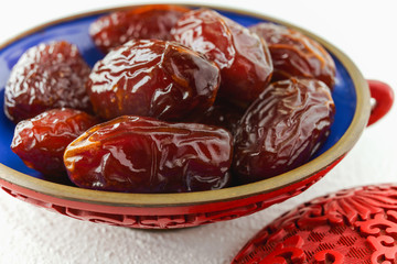 Dates in a bowl close up with white background