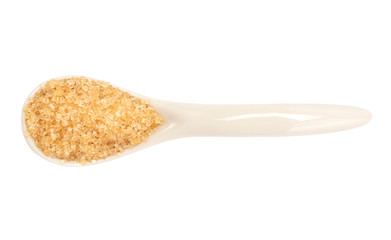 A brown sugar in the ceramic spoon top view with clipping path