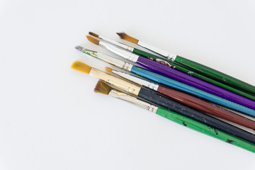 Fototapeta premium a variety of brushes for painting on a neutral white background
