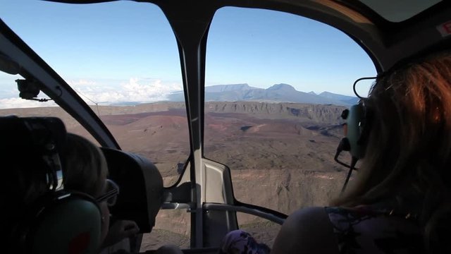Family woman and kid flying in cockpit of helicopter.