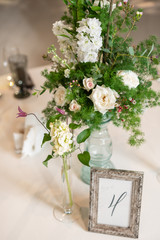 Floral decoration for wedding ceremony romance dining. Wedding banquet , festive decor. Bouquet from spring and summer flowers. Table layout. Restaurant interior. Concept of service and catering.