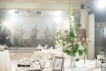 Floral decoration for wedding ceremony romance dining. Wedding banquet , festive decor. Bouquet from spring and summer flowers. Table layout. Restaurant interior. Concept of service and catering.