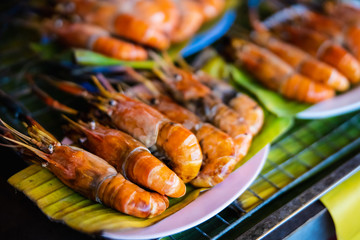 shrimp burned on plate with green leave in thai restaurant