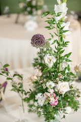 Floral decoration for wedding ceremony romance dining. Wedding banquet , festive decor. Bouquet from spring and summer flowers. Table layout. Restaurant interior. Concept of service and catering.