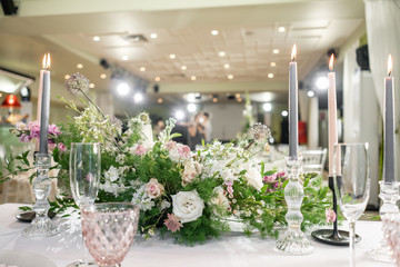 Floral decoration for wedding ceremony romance dining. Wedding banquet , festive decor. Bouquet from spring and summer flowers. Table layout. Restaurant interior. Concept of service and catering.