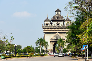 Stunning view of the beautiful Patuxai with daily traffic on the streets of Vientiane, Laos. Patuxai is a war monument in the centre of Vientiane, Laos, built between 1957 and 1968.