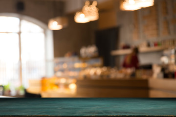 image of wooden table in front of abstract blurred background of resturant lights