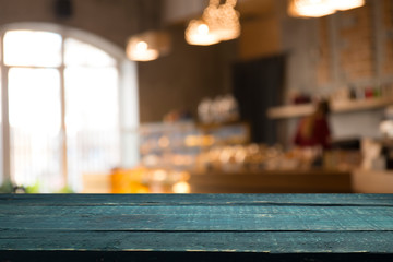 image of wooden table in front of abstract blurred background of resturant lights