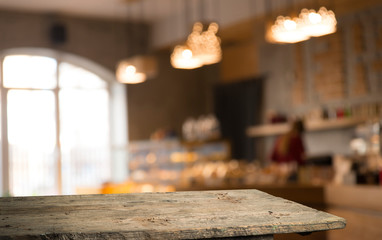 image of wooden table in front of abstract blurred background of resturant lights