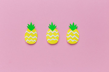 three pineapple on a pink background