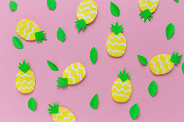 Pink background with pineapples and green leaves