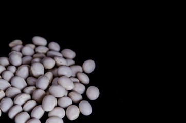 White beans on black background