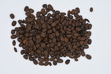 Scattered coffee beans on a white background
