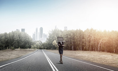 Business woman with laptop instead of head.