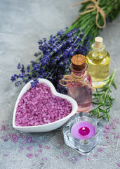 Fototapeta na wymiar Heart-shaped bowl with sea salt and fresh lavender flowers