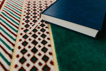 Islamic concept - The holy Quran on a praying matt - Image