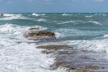 Fototapeta na wymiar Waves Crashing on Rocks on the Southern Italian Mediterranean Coast