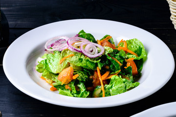 fresh vegetable salad on a black table in cafe restaurant