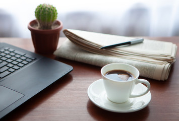 Newspaper with computer on table. Coffee break. 