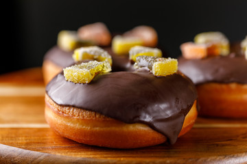 Concept of cooking, baking and food - close-up. Glazed donuts with marmalade decoration.