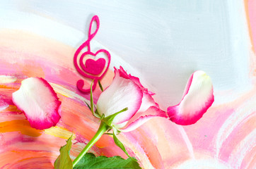 Rose with a decorative heart in the shape of a treble clef with pink felt.
