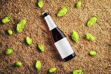 Brown beer mockup with diagonal placement glass bottlle on wheat and single hop cones with  gray label.