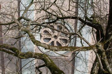ornament of a church through the branches of a tree