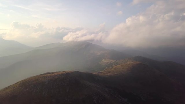 View of the mountains range in clouds from a bird's eye view