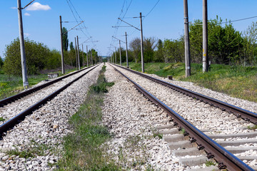 Railway electrified line in the plane. Two tracks are lost in the distance.