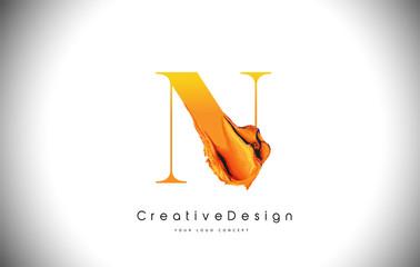 N Orange Letter Design Brush Paint Stroke. Gold Yellow n Letter Logo Icon with Artistic Paintbrush