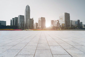 Obraz premium Urban skyscrapers with empty square floor tiles