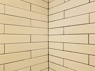 Beige brick wall texture corner, background