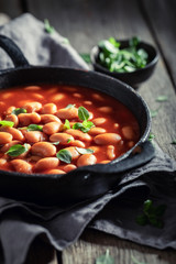 Tasty baked beans made of fresh tomatoes and herbs