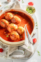 Enjoy your meatballs with fresh herbs and tomatoes