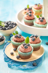 Tasty cupcake made of chocolate cream and berries