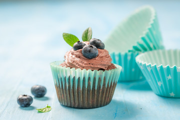 Homemade cupcake made of chocolate cream and berries