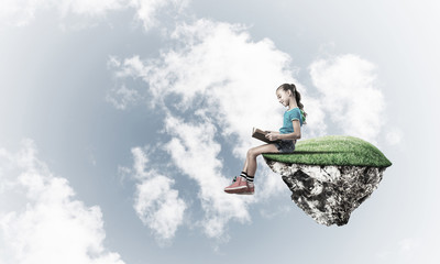 Concept of careless happy childhood with girl reading book