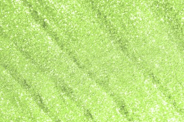 lime glossy sand made of copper glitters with selective focus and small bokeh texture - fantastic abstract photo background
