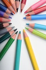 colored pencils on a white background