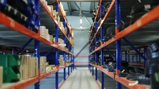 Close-up view of the industrial parts and boxes on shelves inside the industrial stockhouse.