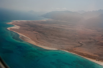 The view from the airplane window on the coast of the amazing island of Socotra in the ocean.