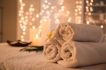 Rolled towels on table in spa salon