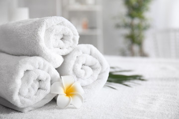 Obraz na płótnie Canvas Rolled towels on table in spa salon