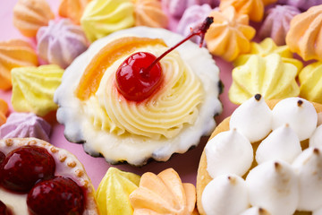 dessert background. delicious assorted cakes. cream cheese cupcake, berry tart, lemon meringue tart. sweet treats and cookies, confectionery